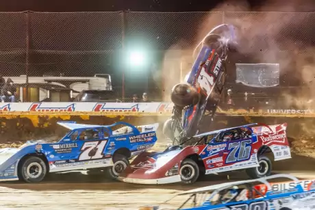 Trey Mills heads over the turn-two wall. (heathlawsonphotos.com)
