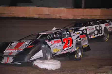 Justin Hirt (27) clipped an infield tire as A.J. Diemel (58) made his winning move. (Shawn Fredenberg)