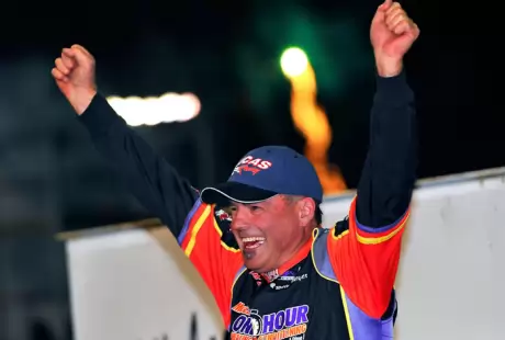 Billy Moyer celebrates as fireworks shoot off in the background. (thesportswire.net)